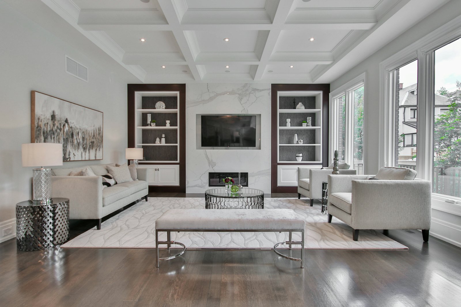 A pale formal room with a stone feature wall behind the seating